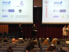 Ms. Brown and Mr. Nagawa present raffle prizes.
